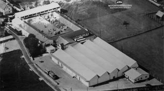 Was 1934 am Marktplatz von Mattighofen als Schlosserwerkstätte begann und 1938 erstmals zwecks Vergrößerung des Reparaturbetriebs und Verkaufs übersiedelte, bezog 1960 einen leerstehenden Vierkanter am heutigen Standort der KTM Fahrrad GmbH. Die 1967 angeschlossene, erste Shed-Halle der "Kraftfahrzeuge Trunkenpolz Mattighofen" existiert noch und wird als Lager genützt.