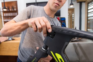As Lars installs the fork from below the head tube, he slides the TT stem onto the steer-tube at the same time. The inner surface of the clamping area has been treated with the red Dynamic fitting grease for carbon.